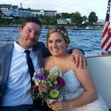 A Bride and Groom sitting on the back seat of the 26' Lyman boat