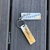 Stainless keychain with Lake Champlain on one side and the silhouette of the lake on the other in black etching.