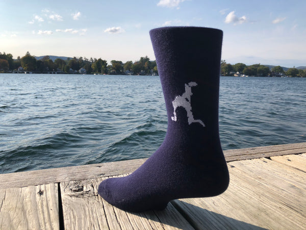 Silhouette of Loon Lake stitched in white on a unisex navy blue sock.