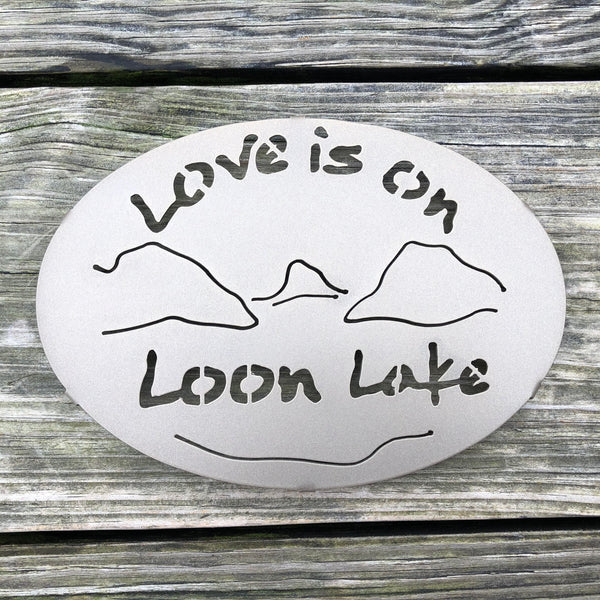 Text Love is on Loon Lake text with the outline of the lake and surrounding Adirondack mountainscape.