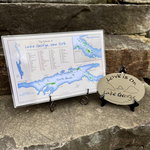 Two-sided laminated placemat that identifies 134 island plus some fun facts about Lake George. It is paired with a Love is on Lake George metal trivet with our lake and mountain scene cut out.