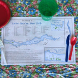 Disposable placemat including a map of the Islands of Lake George  including some fun facts. One-sided; white background, blue lake and green islands with the map of the North Basin.