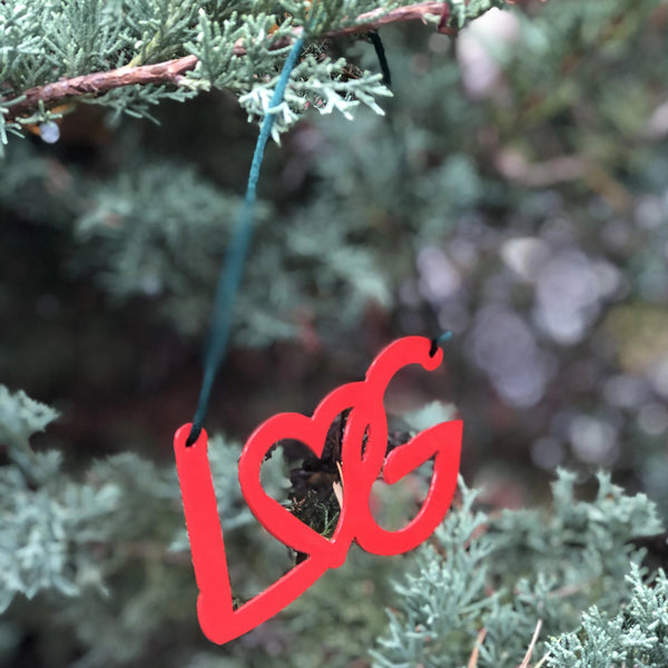 Christmas ornament with the letters LG connected with an interlocking heart and a green ribbon hanger; color red
