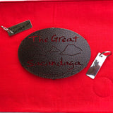 The Great Sacandaga text over/under a lake/mountain scene on a black metal trivet.  It is paired with a stainless Sacandaga keychain that has the silhouette of the lake on oneside. 