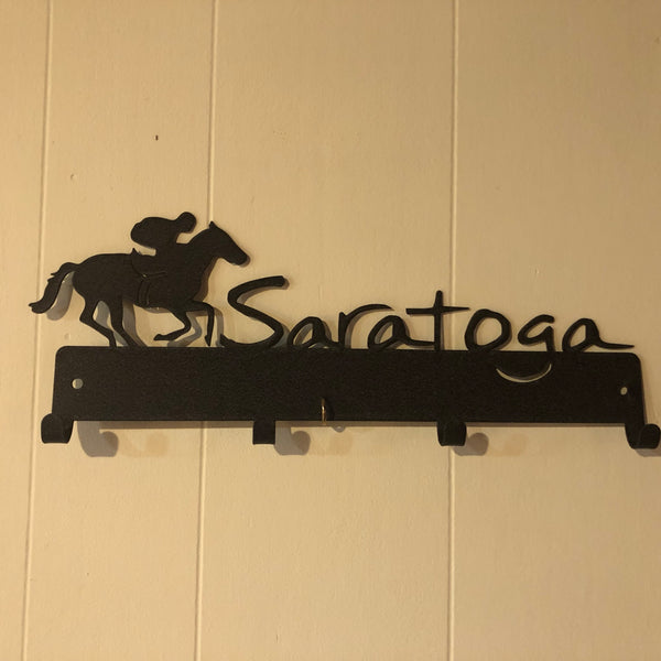 Jockey riding a race horse next to the word Saratoga.