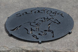 Saratoga text arched over a jockey riding a horse. Color Black
