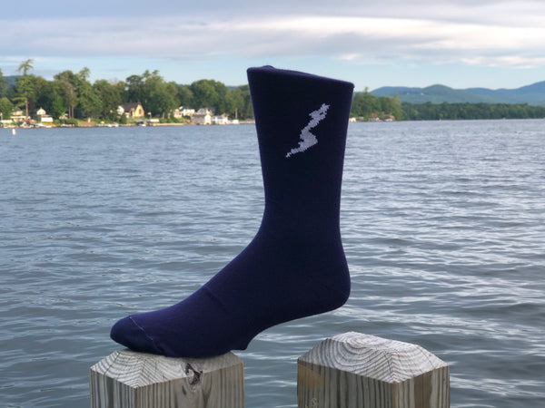 The Silhouette of Schroon Lake stitched in white on a navy blue unisex sock.