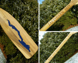 5' wooden oar with the Silhouette of Lake George cut out on the blade and painted lake blue; the Personalizaton Lasered on the oar handle.